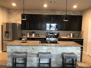 Natural Thin Limestone Veneer in Local Houston Kitchen on Island & Accent Wall