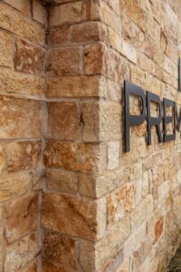 Natural Thin Gold Limestone Facade on Commercial Signage in Houston, TX